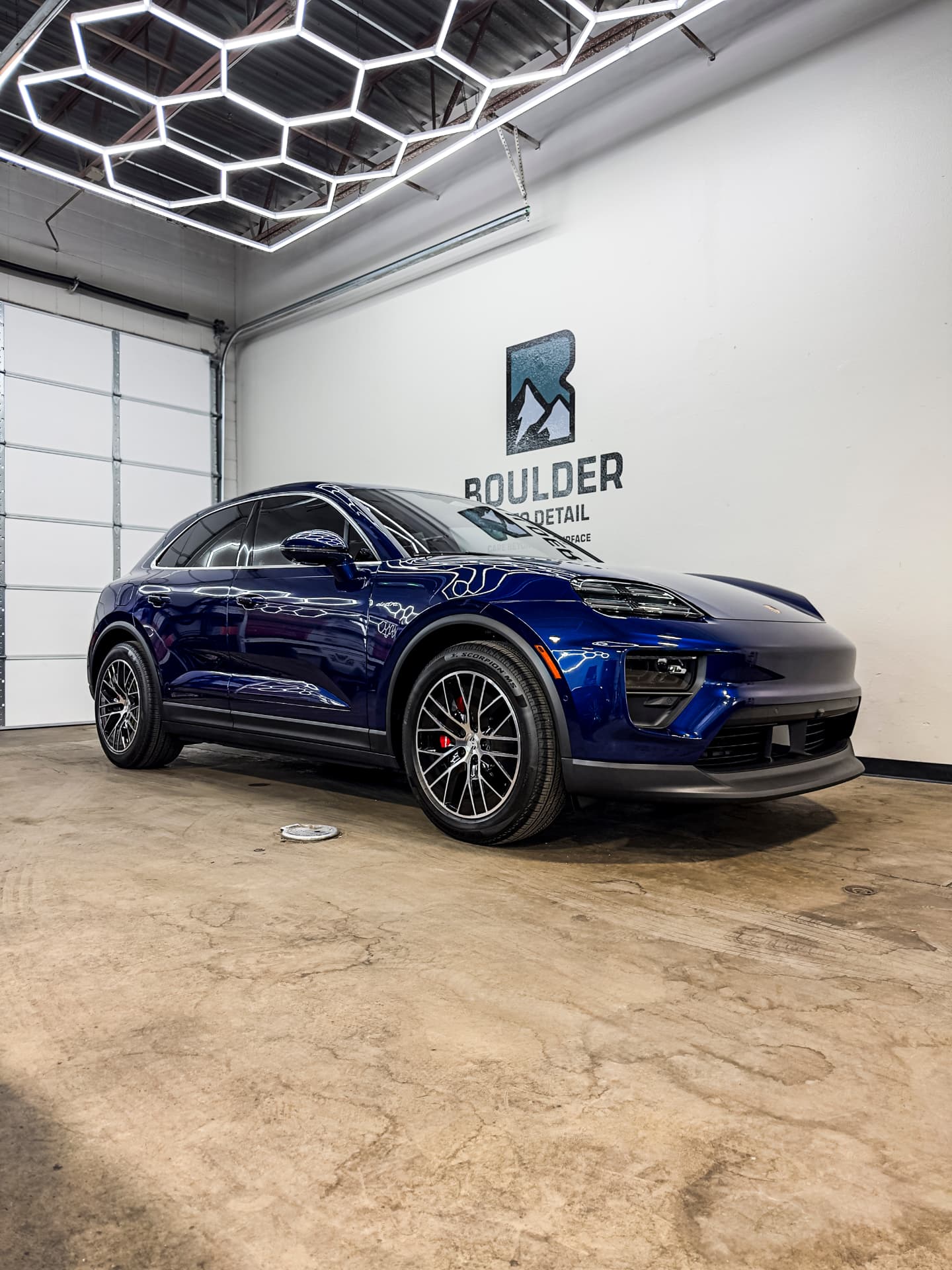 Blue Porsche Macan finished with paint protection film inside the Boulder shop